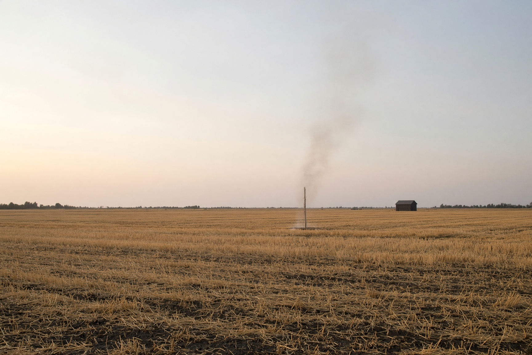 Smoke rising from a field.